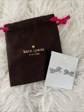 kate spade silver bow stud earrings with pink drawstring pouch